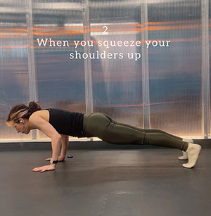 An incorrect body position in chaturanga dandasana because the shoulders are squeezed up to the ears